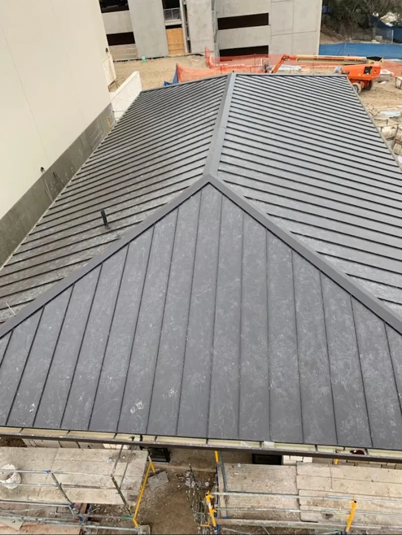 Commercial metal roof construction with crane equipment in East St. Louis