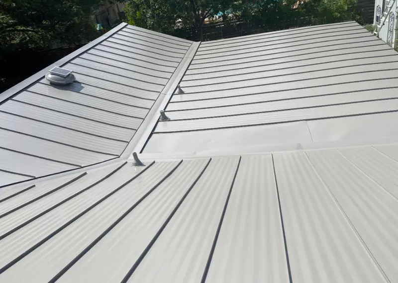 Solar attic fan installed on a metal roof for Roof Ventilation in East St. Louis
